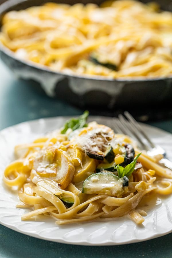 This homemade vegetable fettuccine alfredo is the perfect use for any summer veggies you might have. I use a mix of squash, zucchini, and summer corn! macheesmo.com #alfredo #fettuccine #vegetarian