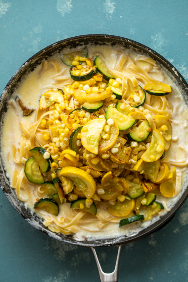 Vegetable Fettuccine Alfredo piled high in a skillet.