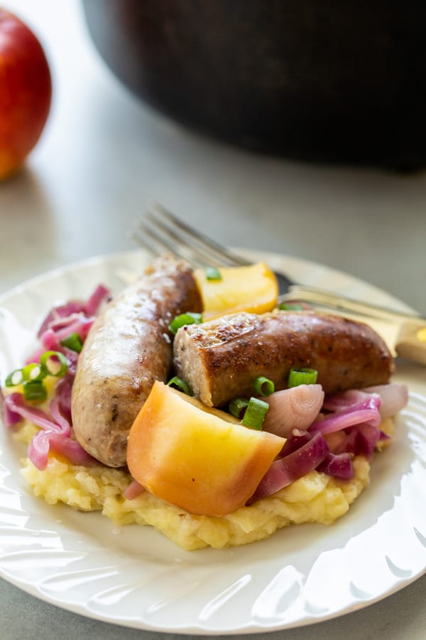 Braised apples and sausage on plates