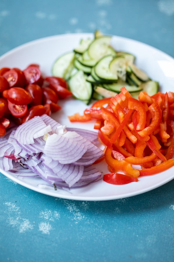 Loads of fresh veggies for chicken bowls.