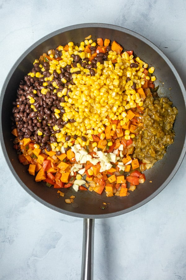 Corn and black beans added to enchilada vegetables.