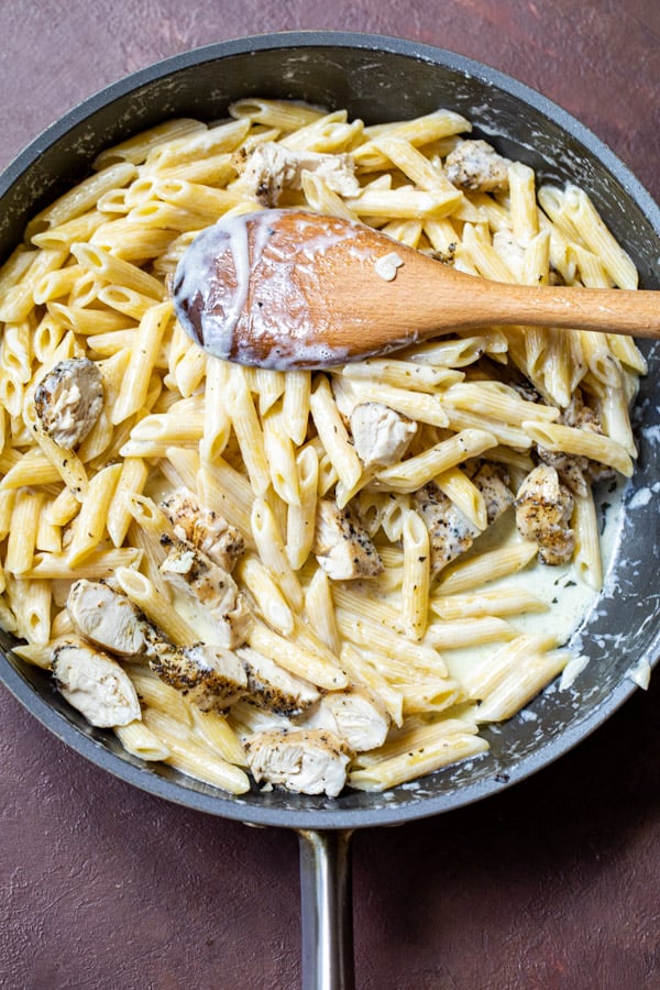 Seared chicken added to alfredo penne.