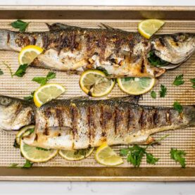 Grilled whole fish on baking sheet