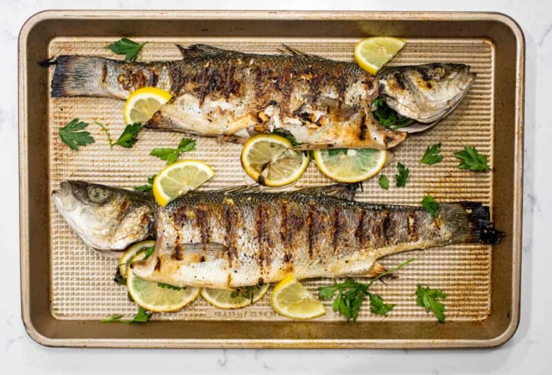 Grilled whole fish on baking sheet