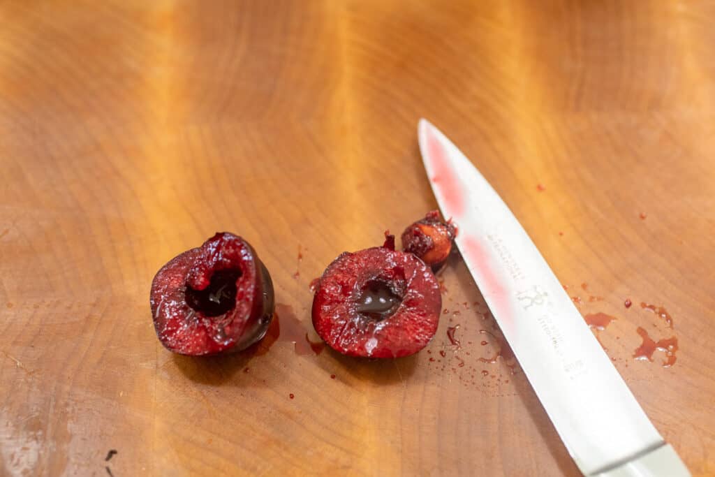 Pitting cherries with a knife.