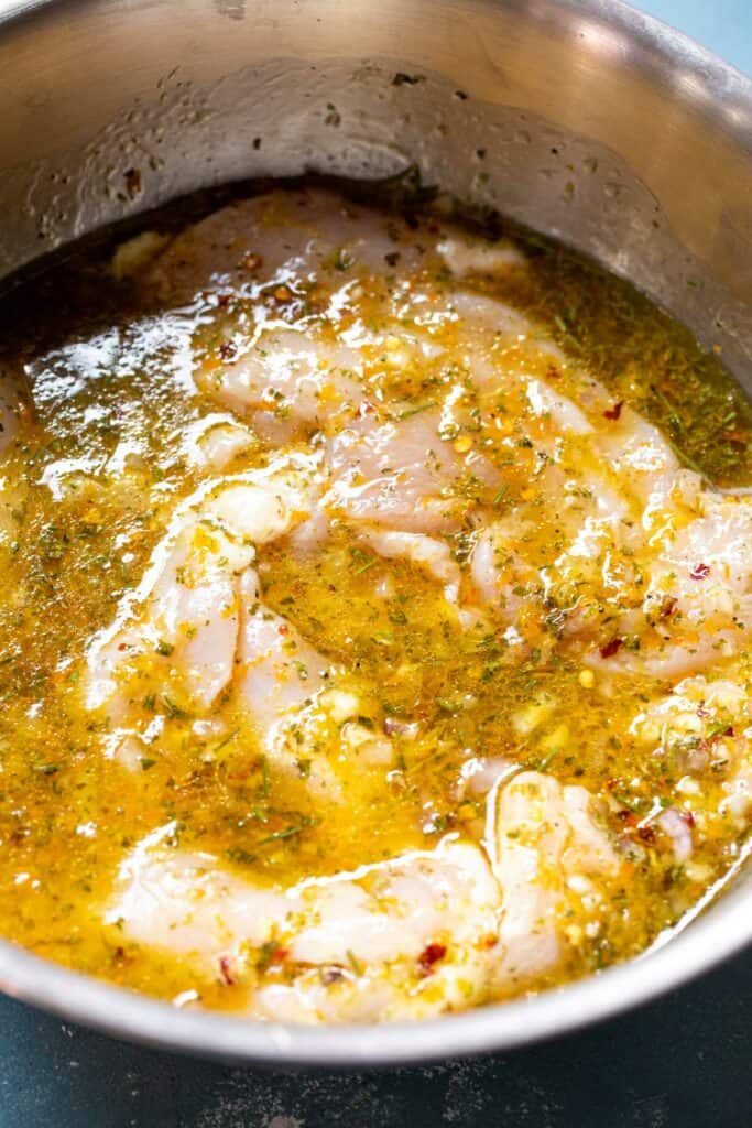 Marinating chicken in citrus marinade.