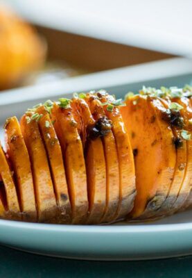 This hasselback sweet potato is delicious and impressive, full of flavor and spices! Perfect for the holidays as a side dish and easy to make in advance! macheesmo.com #hassleback #sweetpotatoes