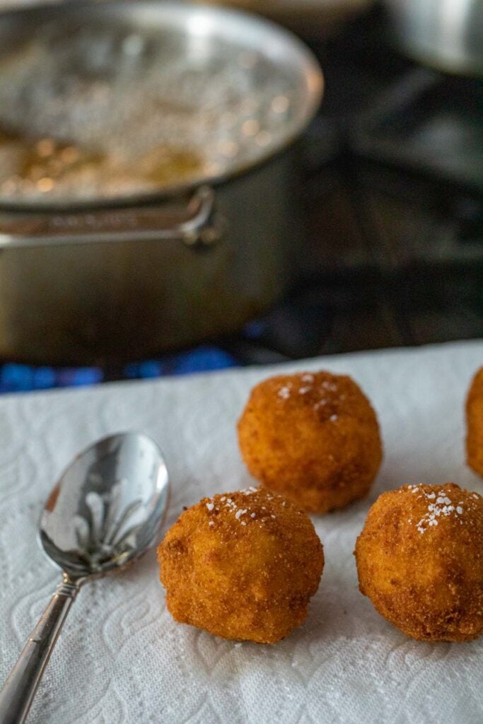 Frying the mac and cheese bites.