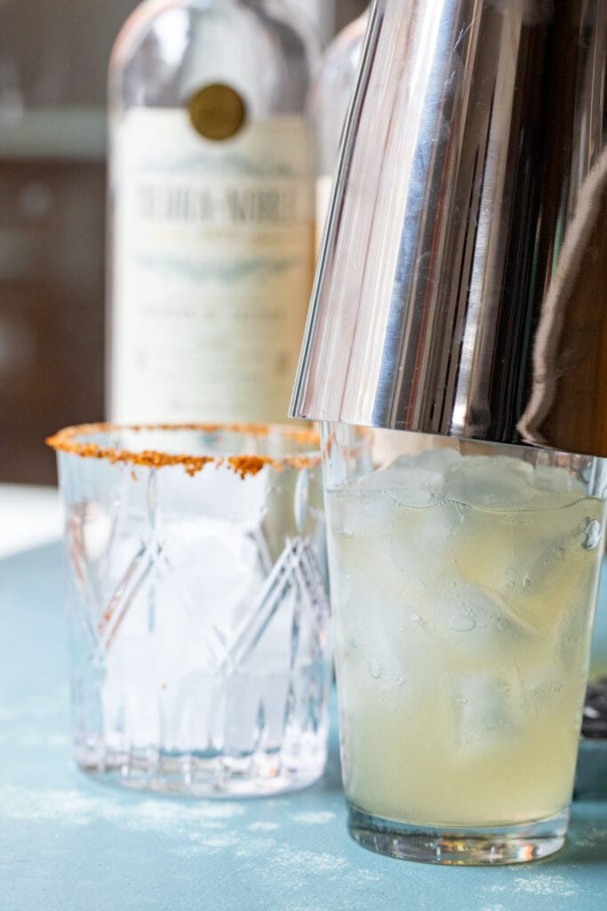 Shaking the ingredients in a cocktail shaker.