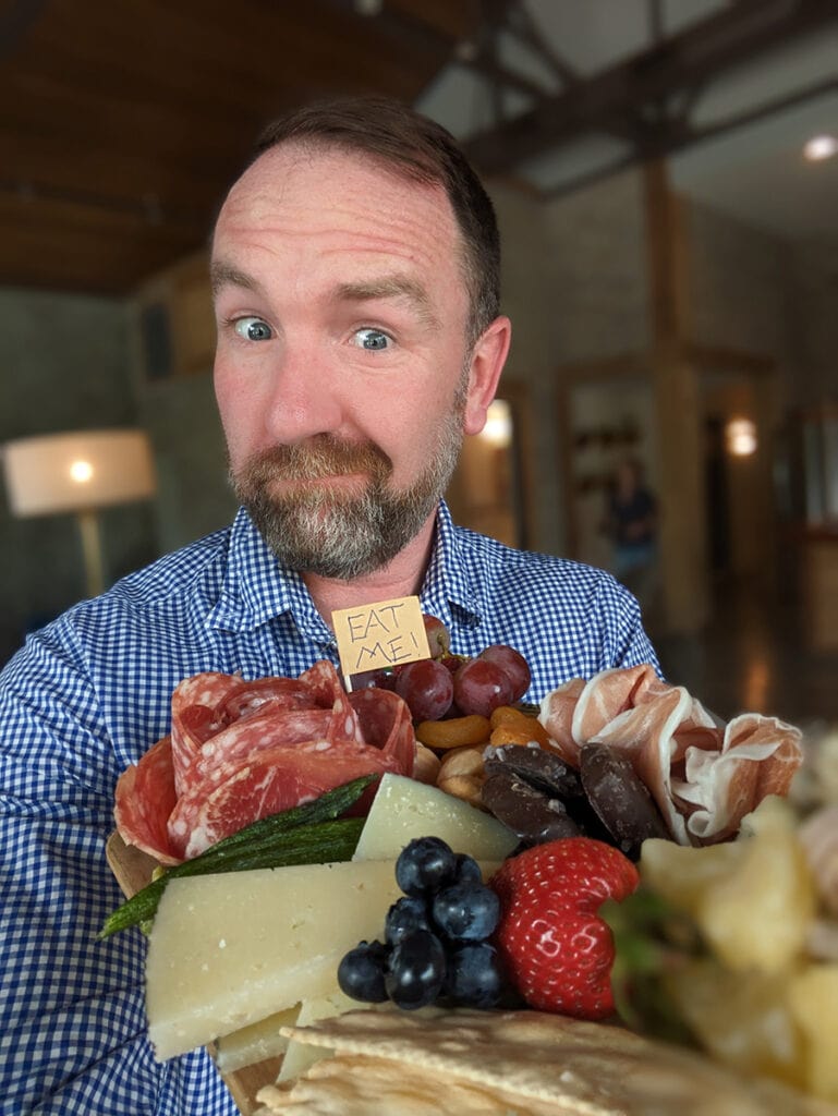 Nick holding a cheeseboard.