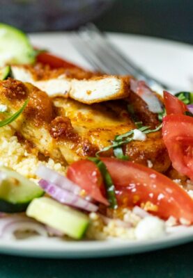 Chicken Couscous with salad on a plate.