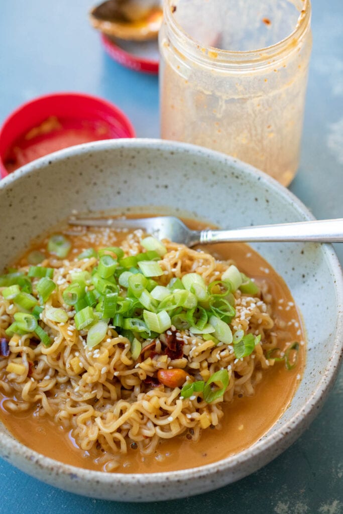 Peanut Butter Noodles with scallions on top.