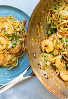 Shrimp Lo Mein on a plate and in wok.