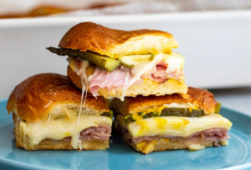 Baked Cuban Sliders on a blue plate.