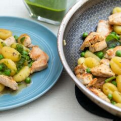 Chicken Gnocchi skillet on a plate with skillet on the side.