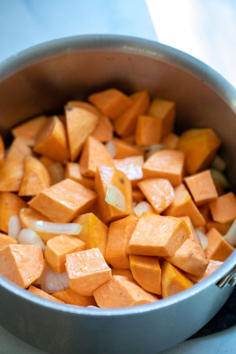 Adding the vegetables to the soup pot.