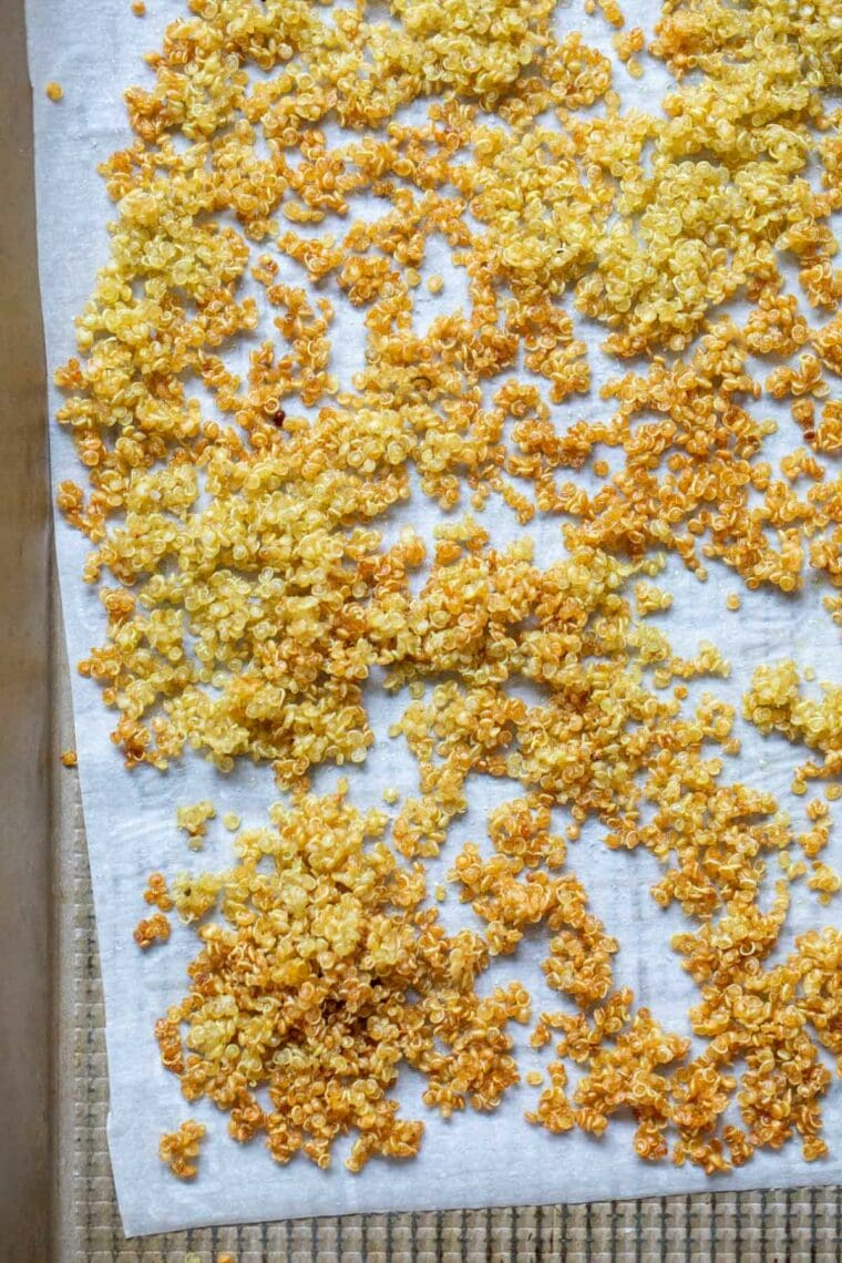 Quinoa baked crispy on a baking sheet.