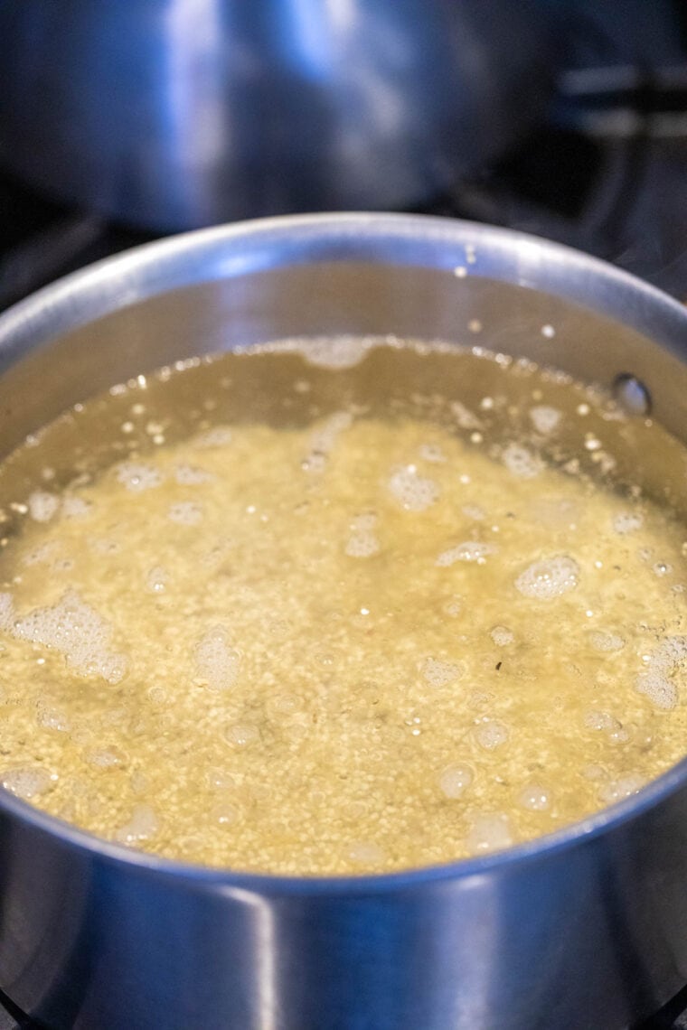 Simmering quinoa in a medium pot.
