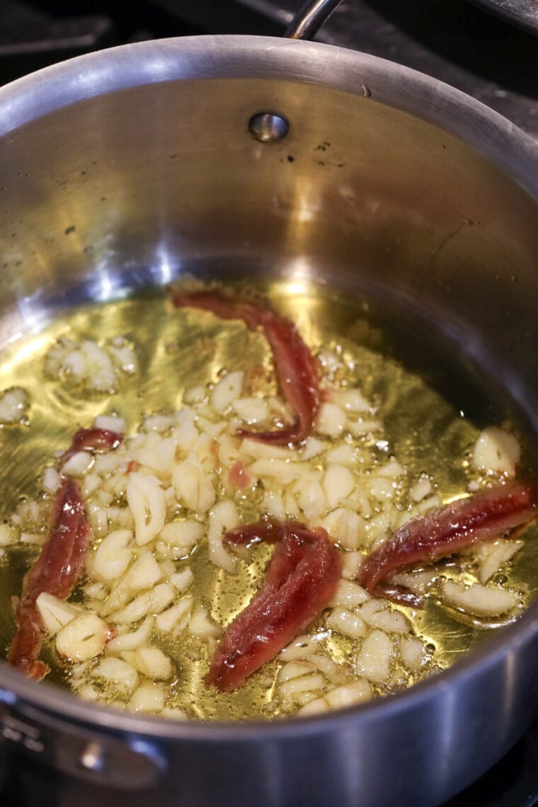 Anchovies and garlic frying.