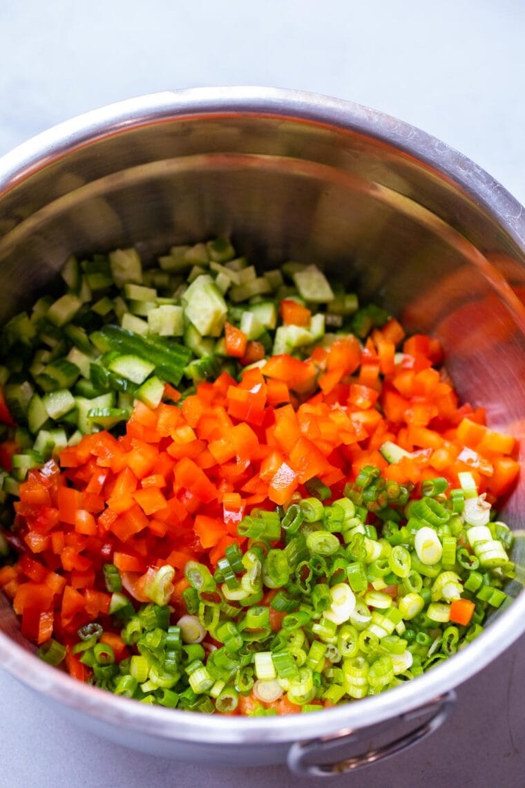 Chopped vegetables added to dip.
