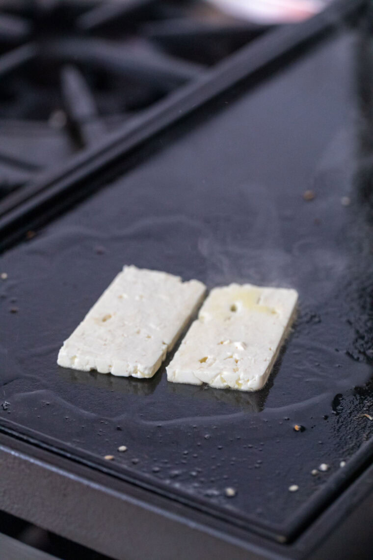 Cooking feta on a griddle.