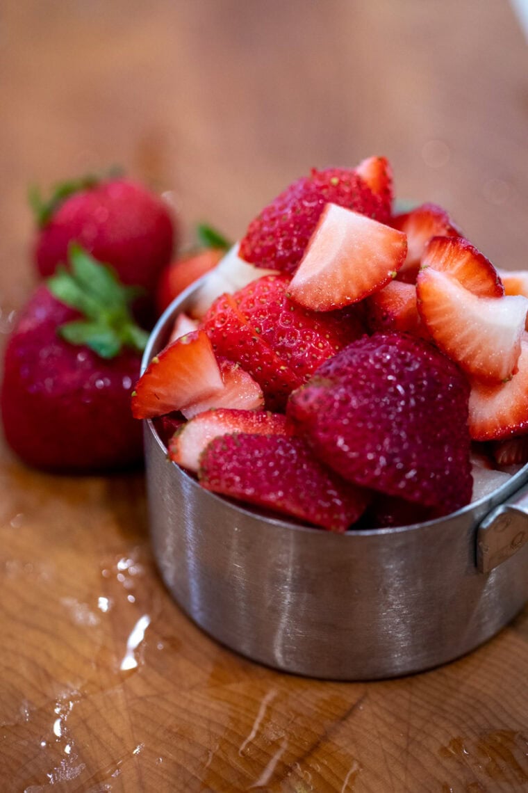 Strawberries sliced for syrup.