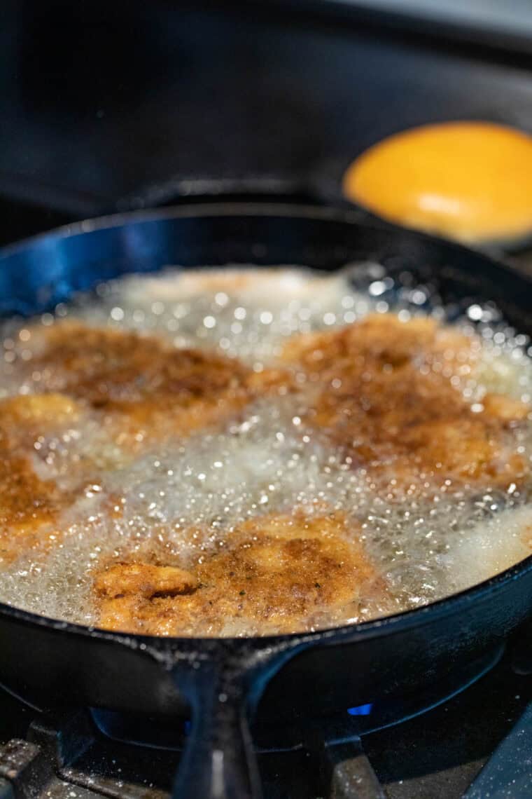 Frying chicken thighs.