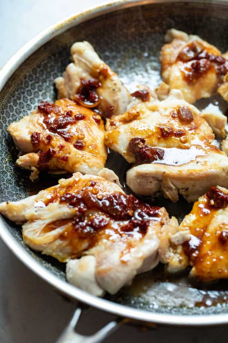 Saucing the chicken.